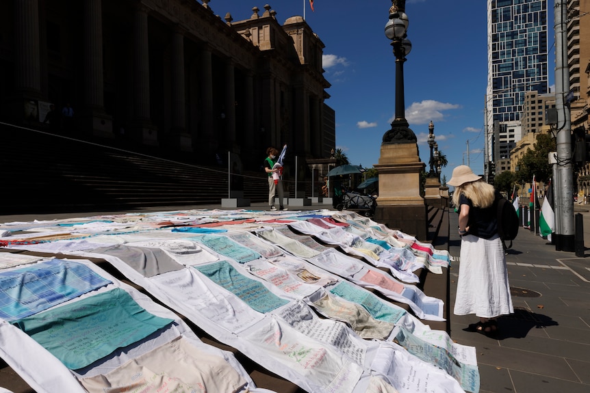 The steps of Parliament in Victoria covered with pillow cases with messages written on them.