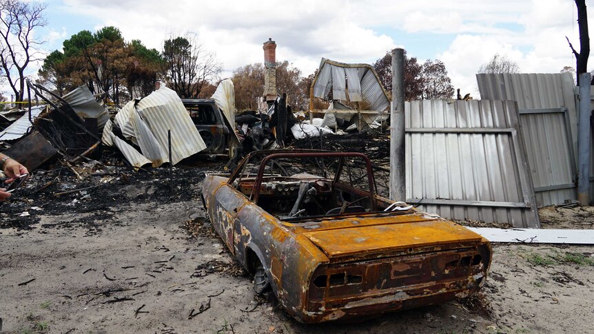 Burnt-out car and buildings in the bushfire devastated town of Yarloop.