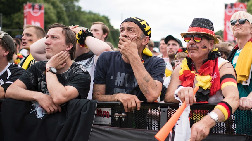 German fans look sad while watching a big screen