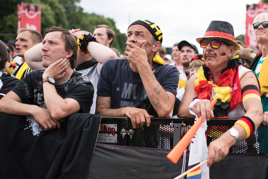 German fans look sad while watching a big screen