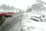 A car is pulled from the side of the road after slipping on ice.