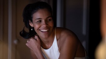 The actor Zahra Newman in the film Long Story Short, smiling in a white dress