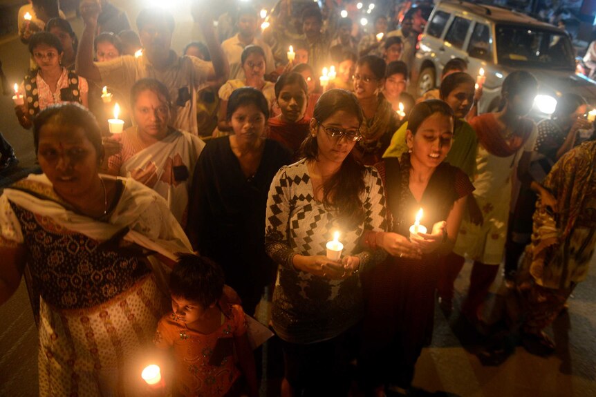 Indians take part in a candlelight vigil at the site of the bomb blasts at Dilsukh Nagar in Hyderabad.