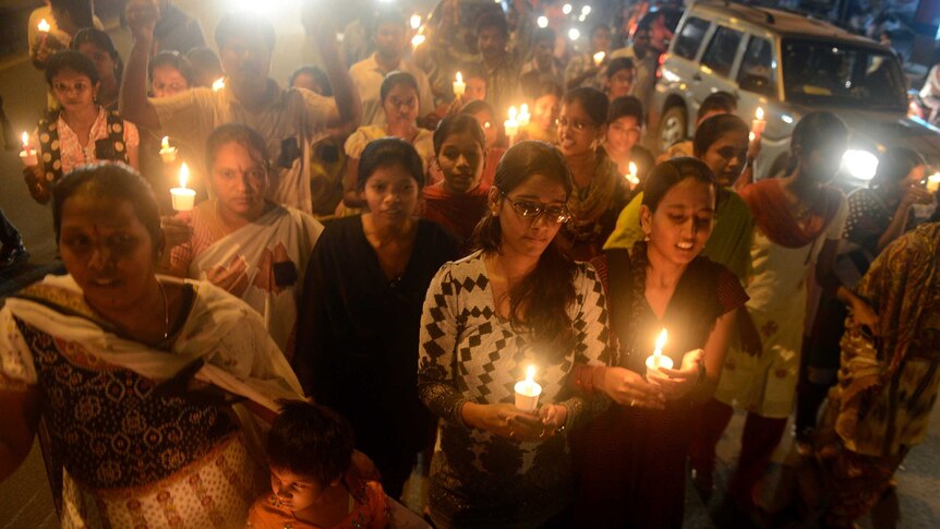 Indians take part in a candlelight vigil at the site of the bomb blasts at Dilsukh Nagar in Hyderabad.