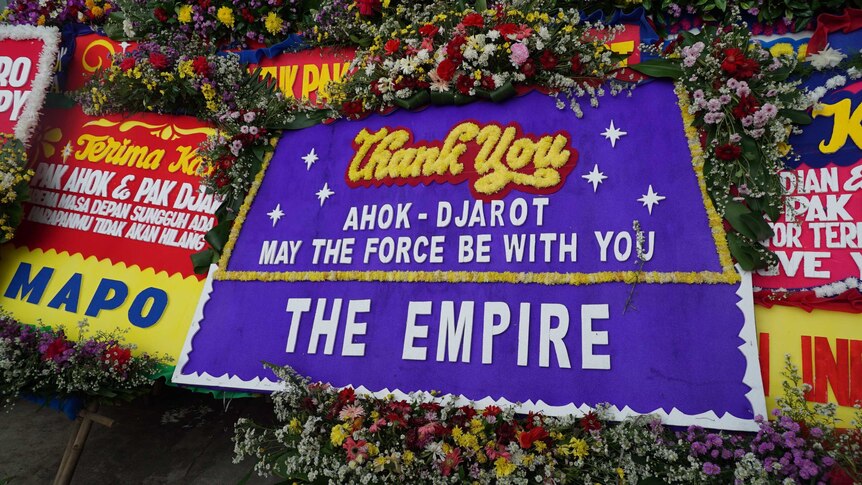 A purple board reads "Ahok Djarot may the force be with you - The empire"