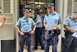 A group of police officers outside a building