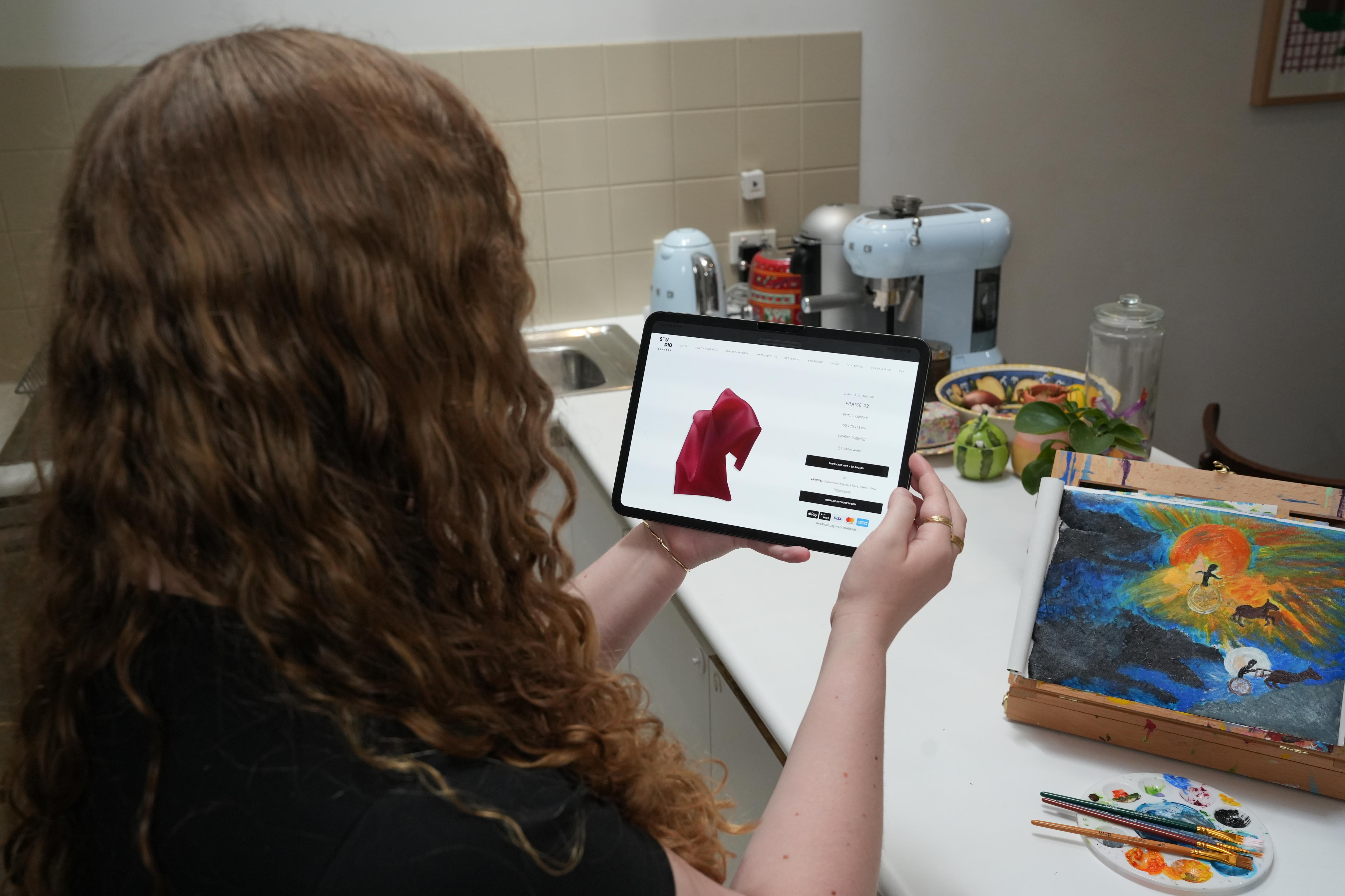 Eliza looks Jean Paul Mangin on ipad