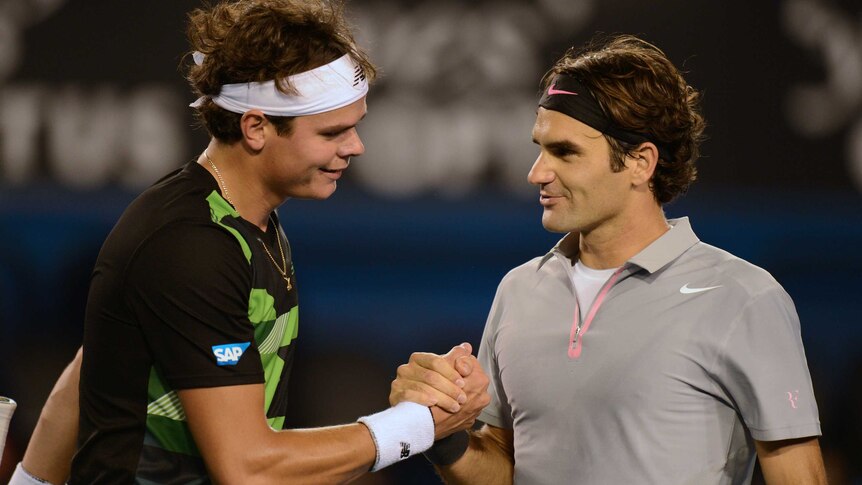 Switzerland's Roger Federer (R) shakes hands with Canada's Milos Raonic