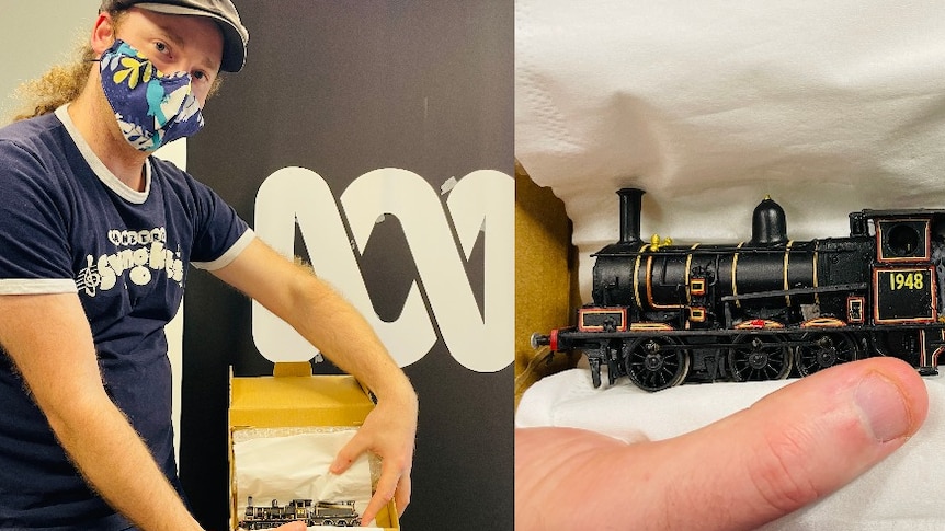 Kevin Tiernana holds a model locomotive.