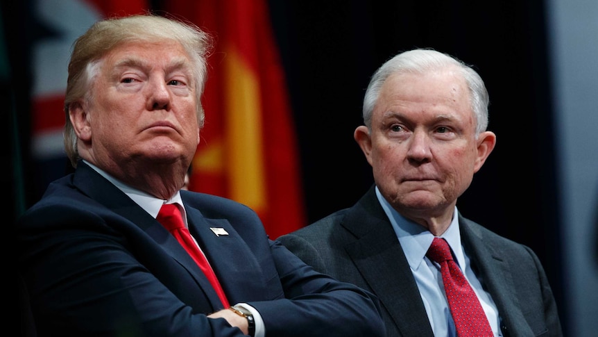 Donald Trump and Jeff Sessions sit together.
