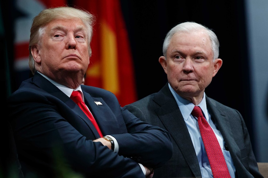 Donald Trump and Jeff Sessions sit together.