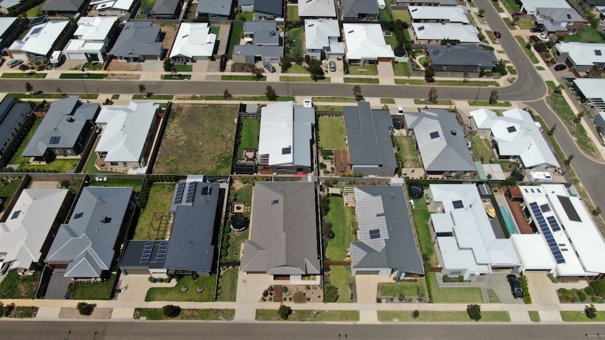 A drone photo of a housing estate shows large houses built very close together on small blocks.