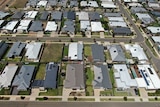 A drone photo of a housing estate shows large houses built very close together on small blocks.