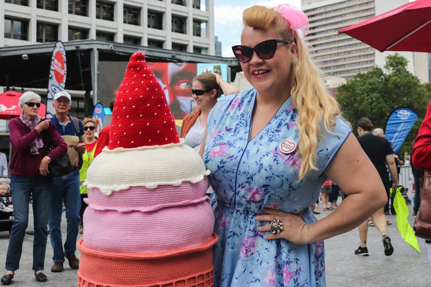 Woman holding a crocheted sundae.