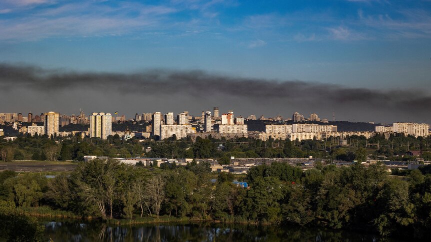 Black smoke rises over the city of Kyiv.