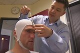 North Melbourne forward Leigh Adams being checked by a doctors for a study into the brains of football players who have suffered repeated knocks to the head October 9, 2015