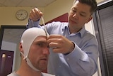 North Melbourne forward Leigh Adams being checked by a doctors for a study into the brains of football players who have suffered repeated knocks to the head October 9, 2015