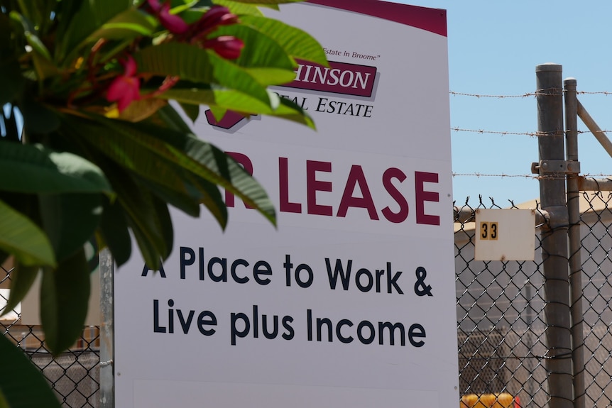 A for lease sign stationed in a Broome industrial area behind a tree. 