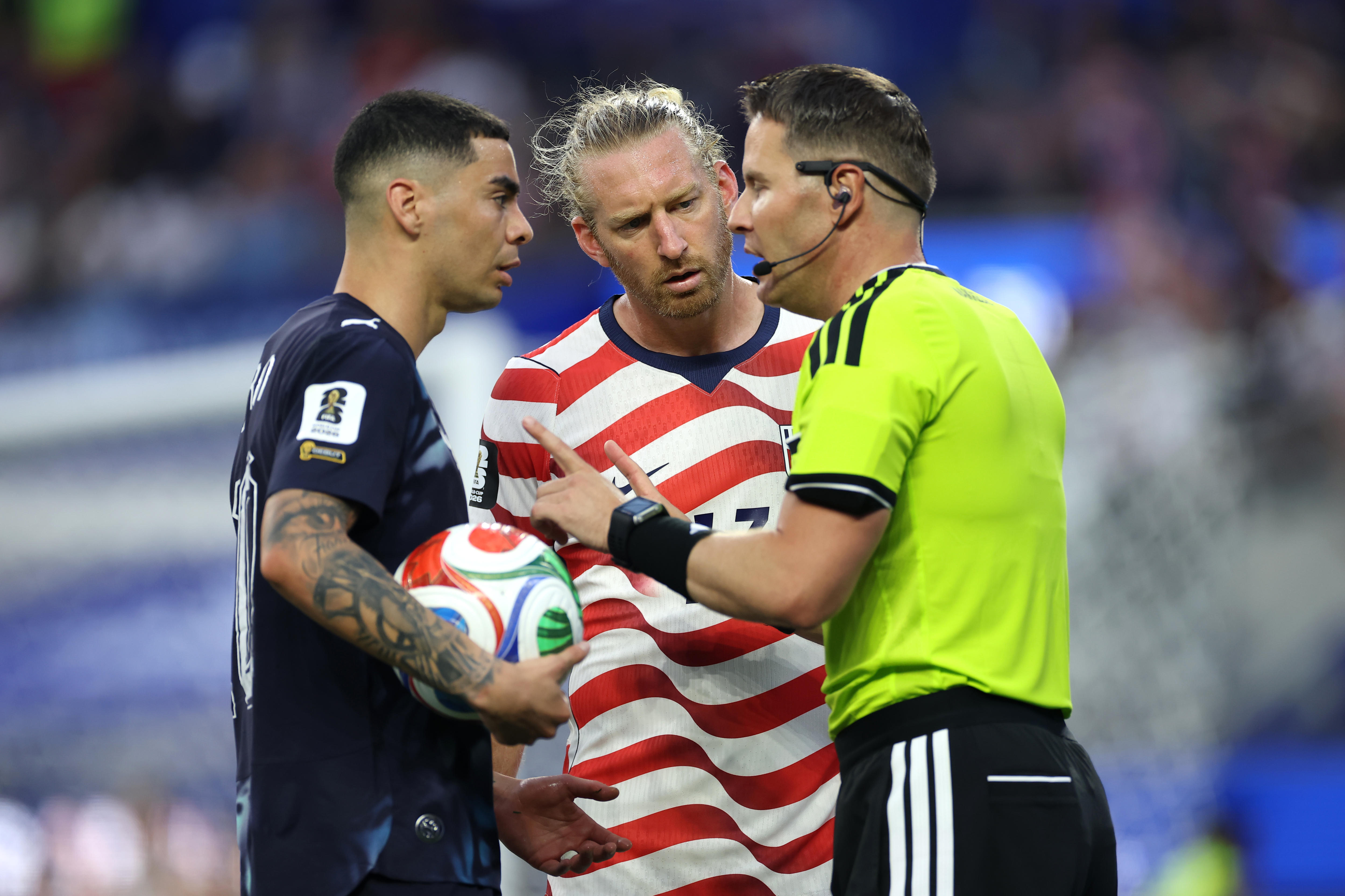 Miguel Almirón is spoken to by the referee