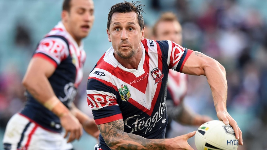 The Roosters' Mitchell Pearce (C) passes the ball against the Cowboys in round 23, 2016.