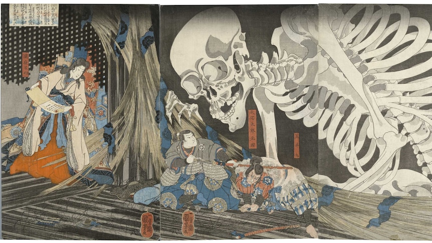 Enormous skeleton peers over two male figures in traditional Japanese robes. A woman holding an unravelled scroll stands aside.