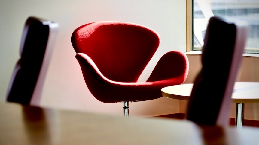 A red chair in a boardroom.