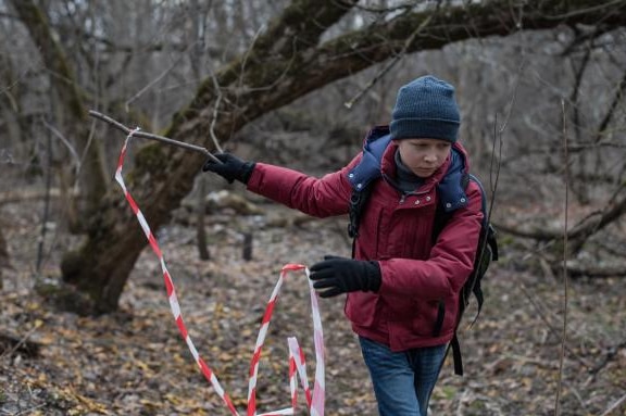 Photograph from 2018 film Loveless of Matvey Novikov walking through the woods wearing warm clothing.