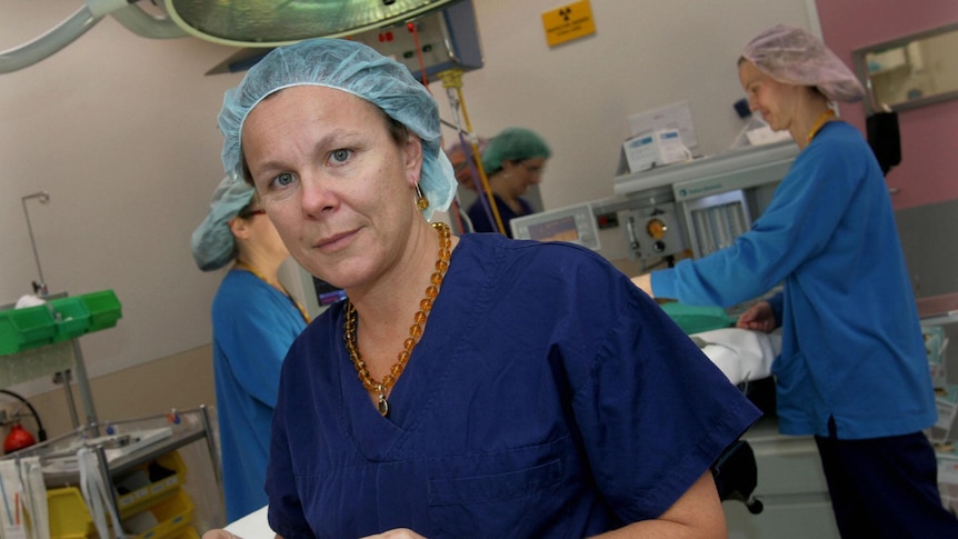 Professor Fiona Wood wearing scrubs in an operating theatre.