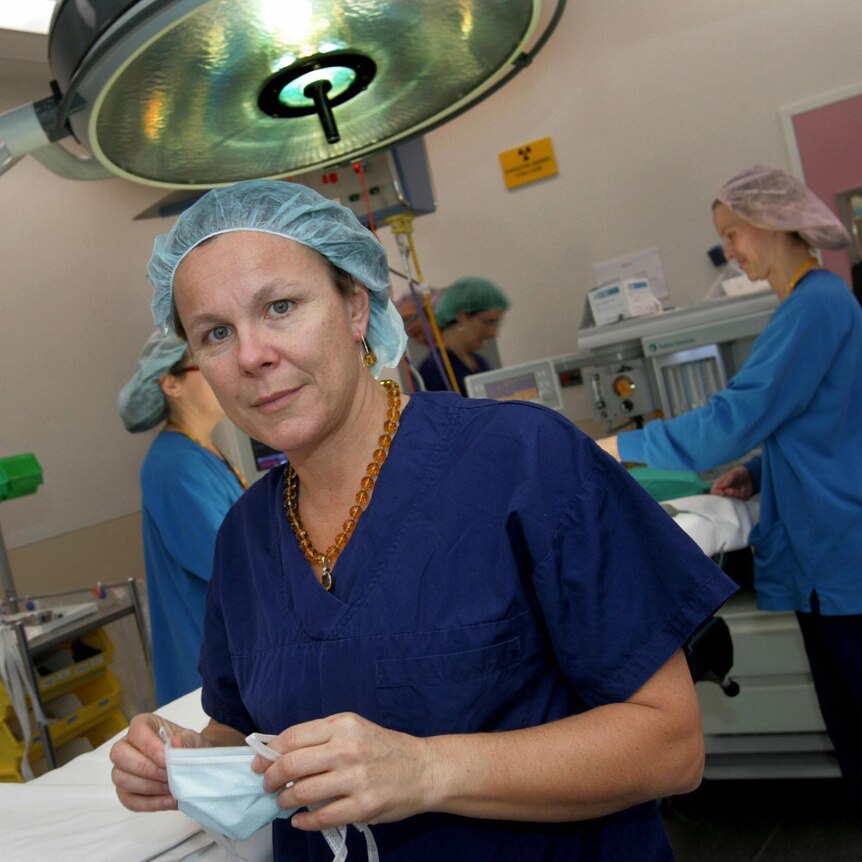Professor Fiona Wood wearing scrubs in an operating theatre.