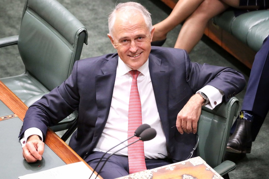 Malcolm Turnbull looks at the camera and smiles broadly as he sits in the House of Representatives Chamber.