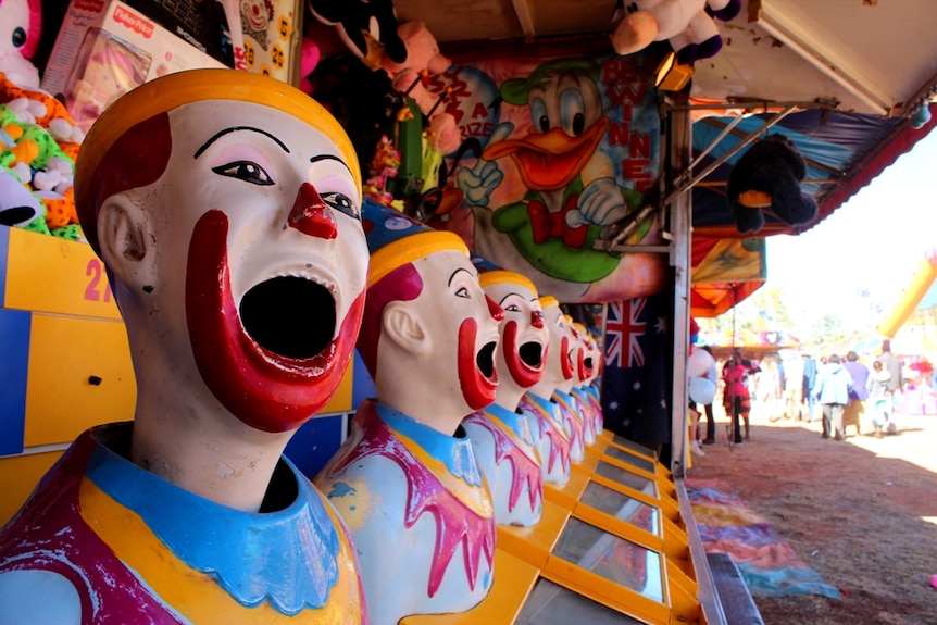Laughing clowns in sideshow alley.