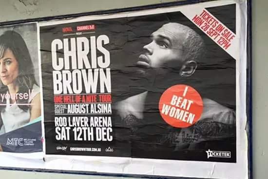 "I Beat Women" sticker placed on Chris Brown concert promotion poster