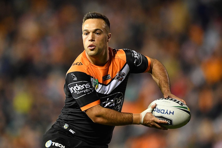Luke Brooks prepares to pass the ball for the Wests Tigers.