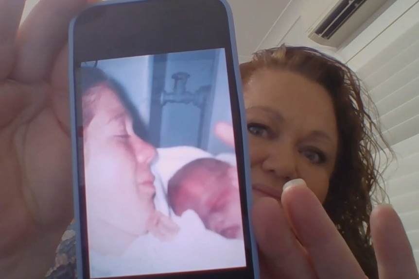 Woman showing screenshot of her and a baby 