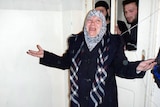 Syrian woman reacts after leaving morgue housing victims of alleged massacre