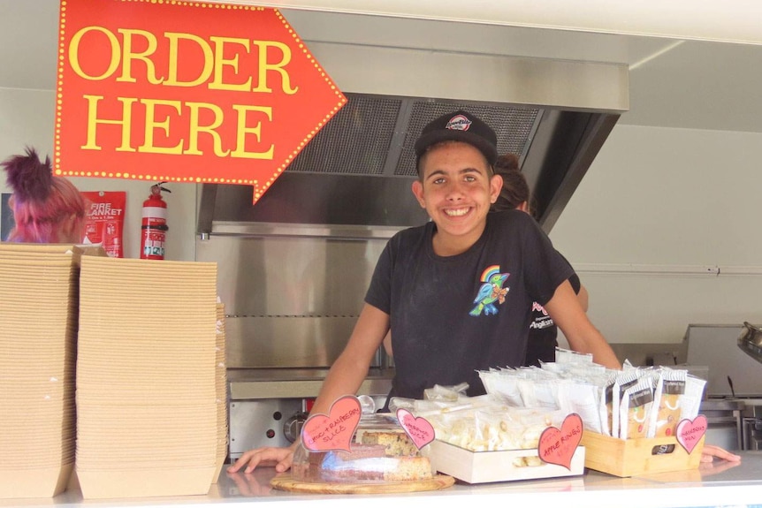 Teenager Raymond smiles as he works in the Good Grub Club food van in Brisbane.