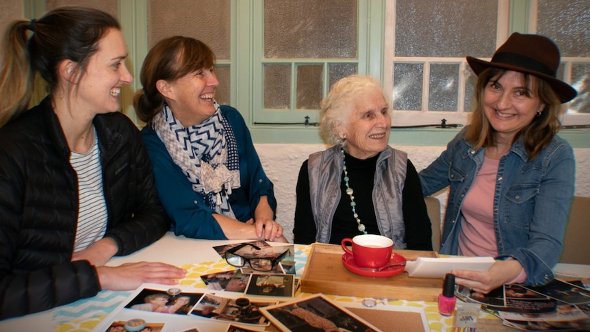 Four women sit around a table