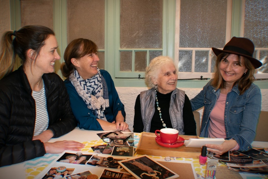 Four women sit around a table