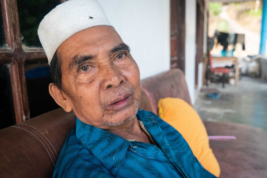 An Indonesian man sitting on a couch