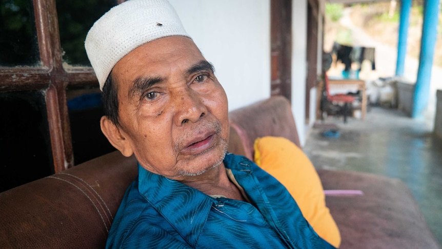 An Indonesian man sitting on a couch