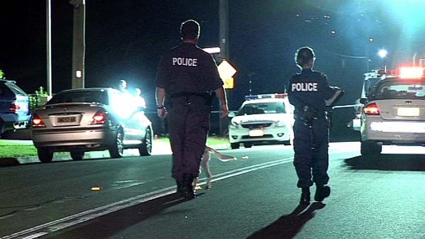 Police walk down Frances Street in Merrylands, western Sydney, after a drive-by shooting there