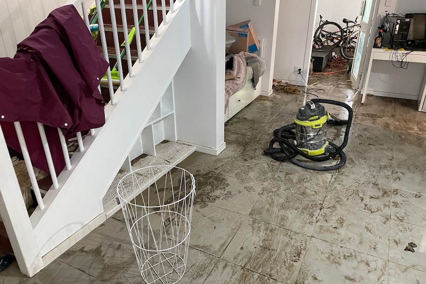 Muddy stairs and flooring after a flood in a home at Deagon on Brisbane northside.