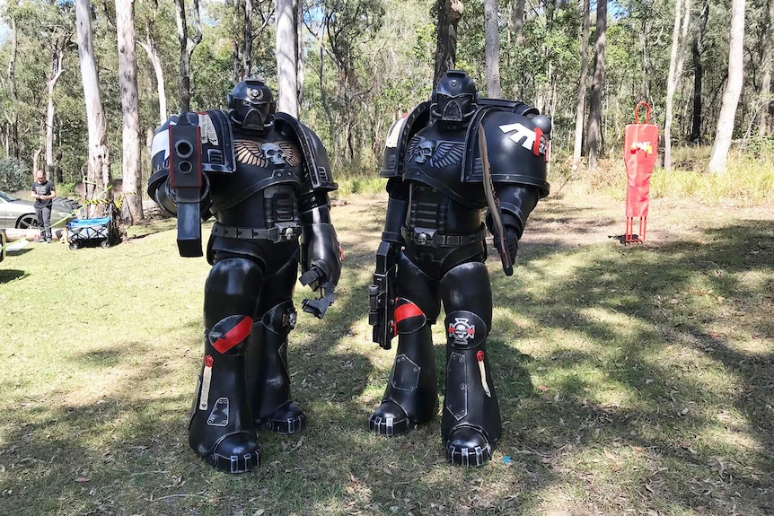 Two people dressed in Transformers-style costumes holding gel ball blasters for game of Gel ball on Gold Coast.