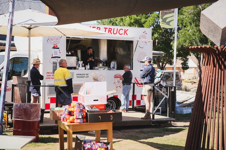 A coffee van set up in a little town square.