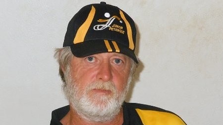 Man wearing sports gear and cap poses for camera