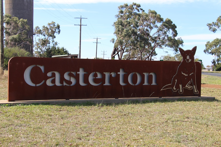 A big entrance sign reading 'Casterton' with a kelpie dog sign on the side