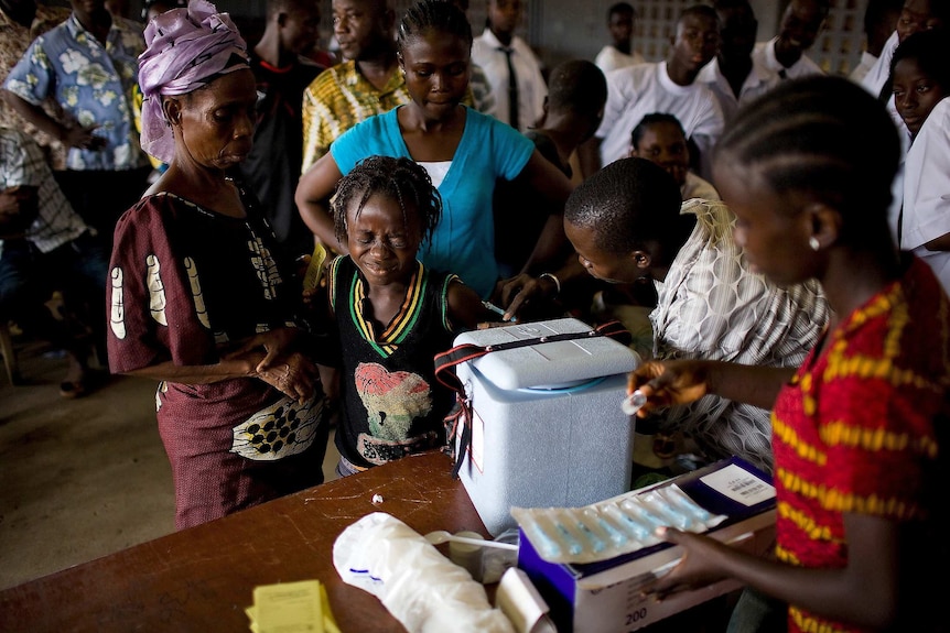 A young girl gets a yellow fever vaccine