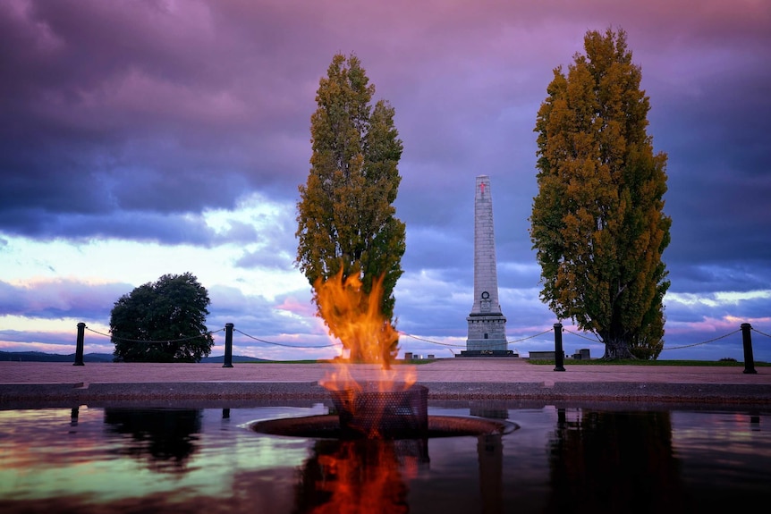 Eternal flame burning in centre of a pond at the Hobart Cenotaph.