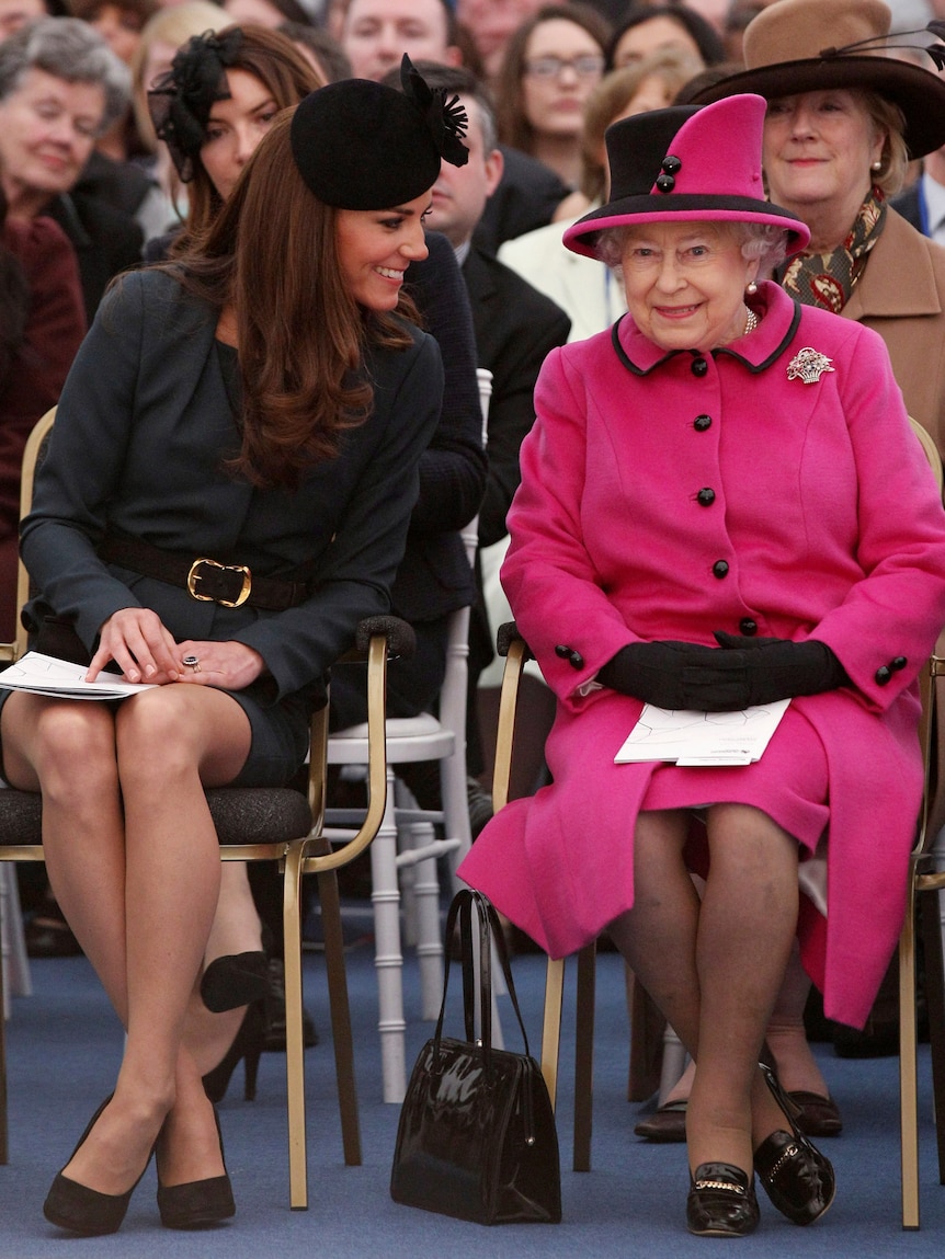 Queen Elizabeth and Catherine, Duchess of Cambridge watch a fashion show