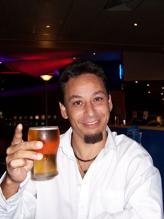 Man in white shirt with a beer